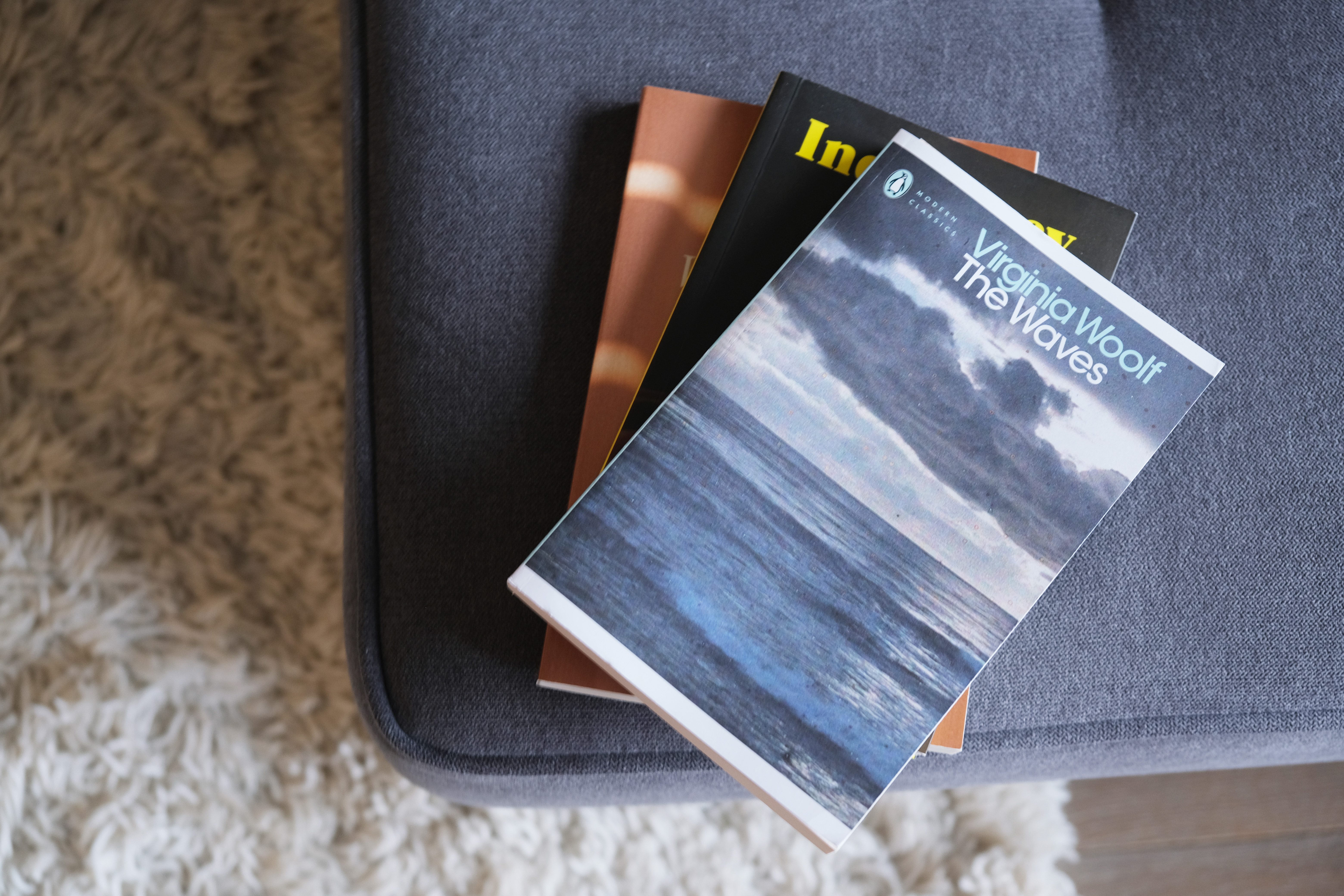 Three books on a sofa